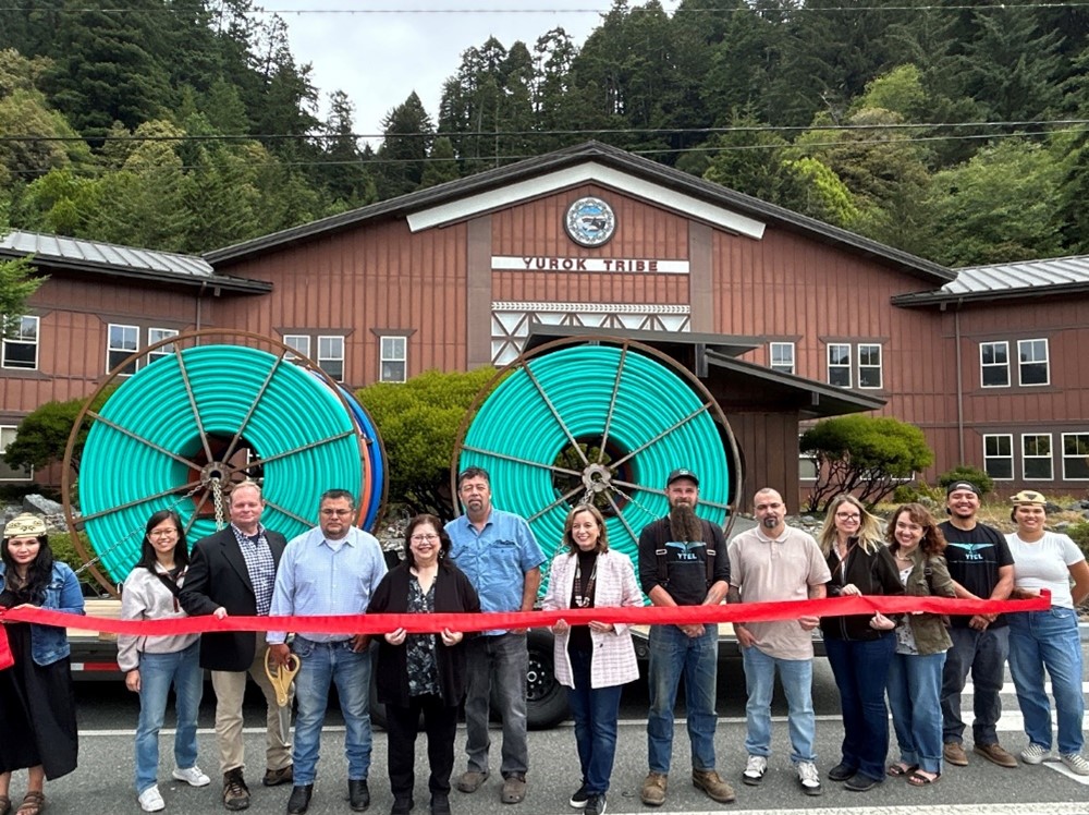 Leaders of the Yurok Tribe, YTel, and CDT gather for a ribbon cutting outside the Yurok Tribal headquarters.