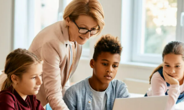 Teacher and students using the internet.